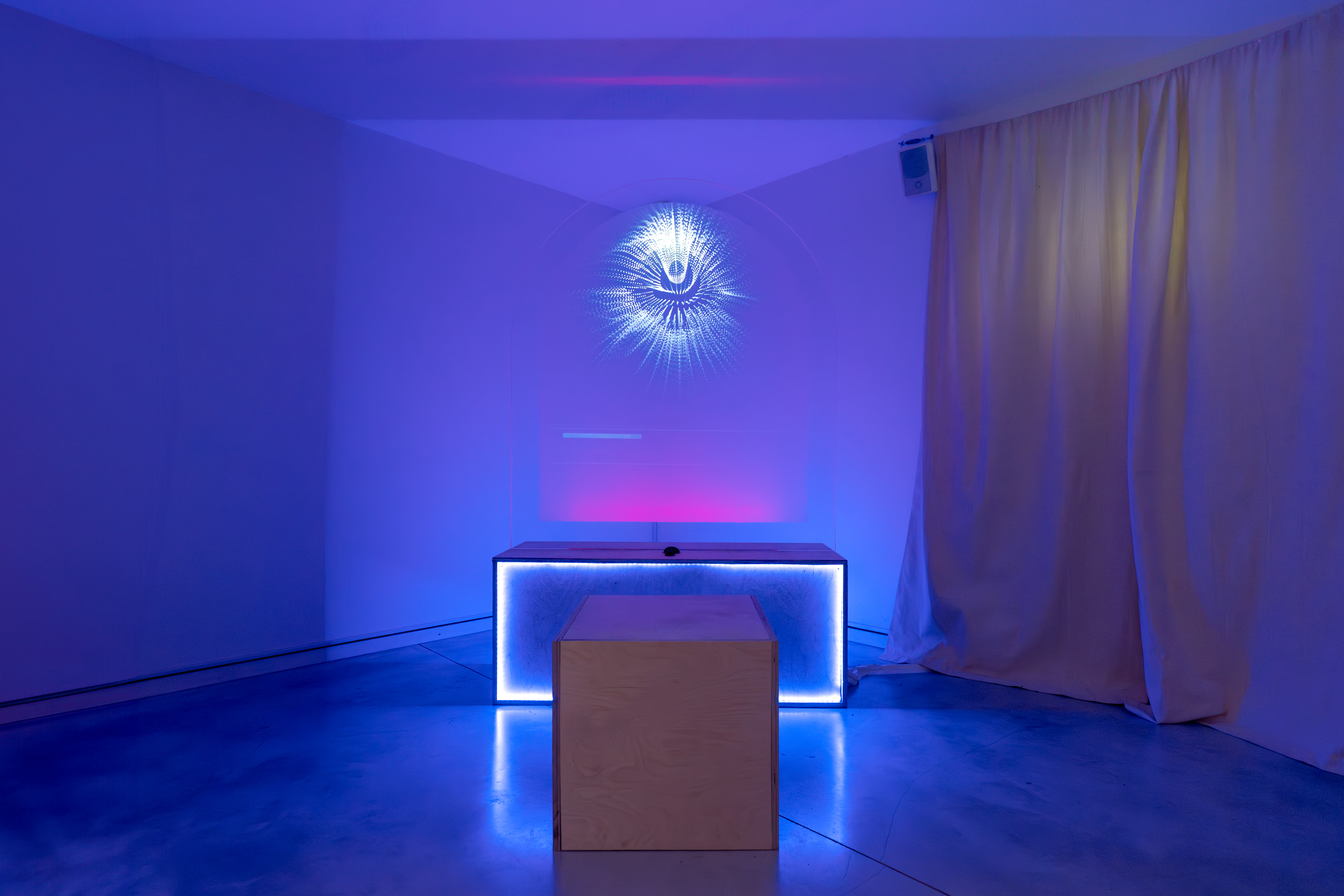 Good Measure installation room with blue lighting and monolith